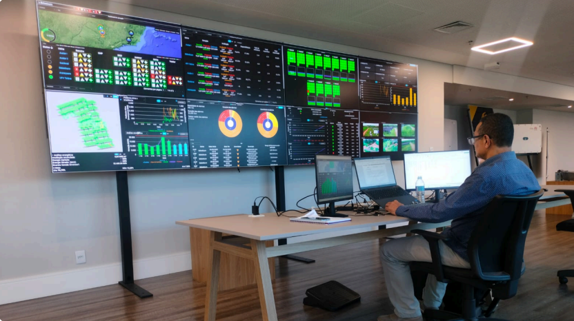 TECSCI operations center with a video wall showing monitoring dashboards